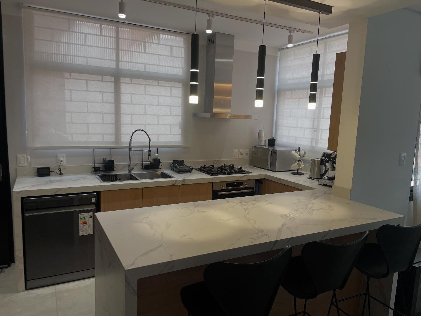 Cocina con isla y mesada en cascada en Dekton Aura — Montevideo · Nuevo Horizonte Marmolería